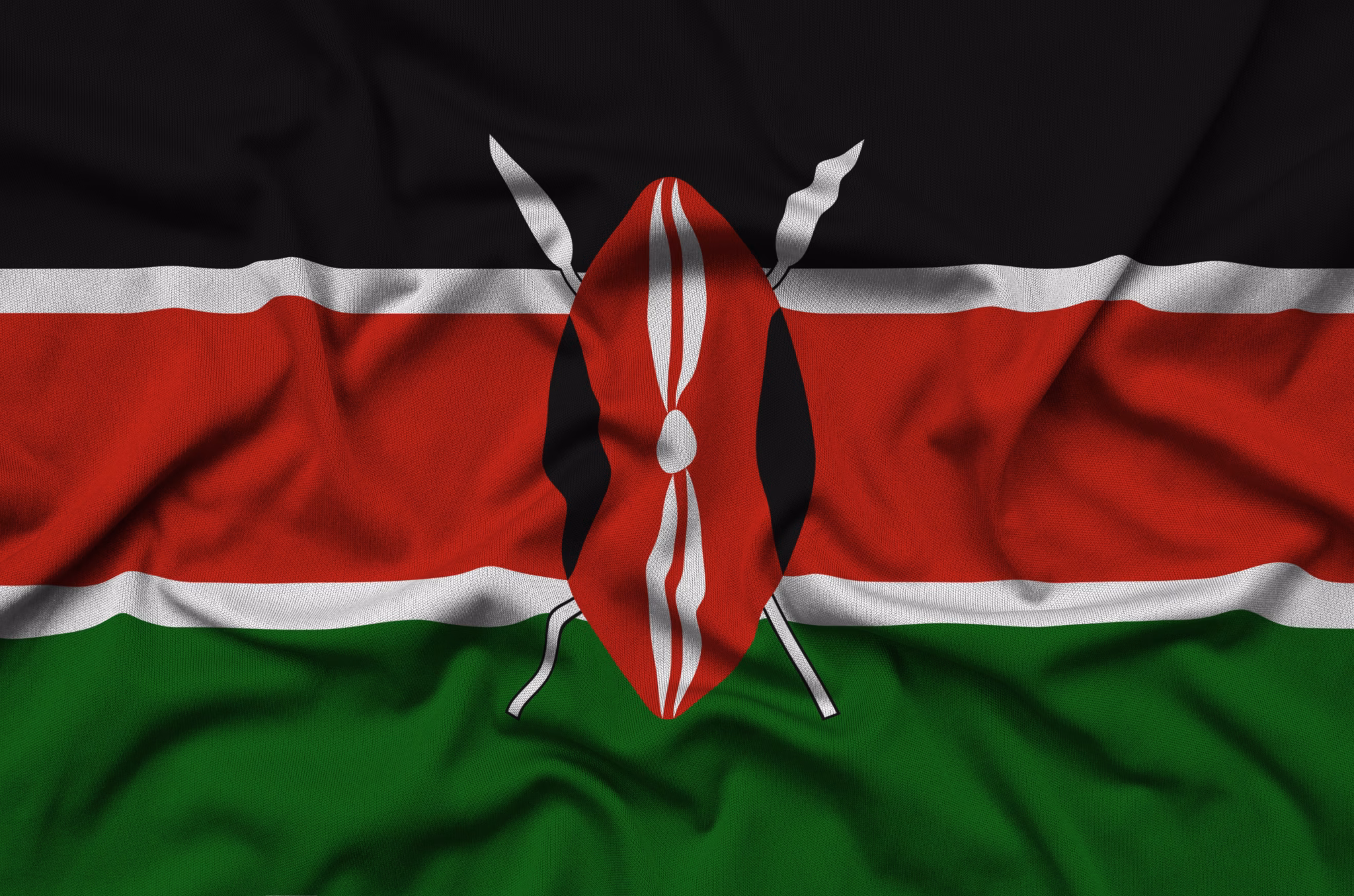Kenya flag  is depicted on a sports cloth fabric with many folds. Sport team waving banner